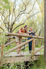 Hikers exploring nature on wooden bridge in madrid