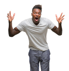 Naklejka premium Young african american man over isolated background celebrating crazy and amazed for success with arms raised and open eyes screaming excited. Winner concept