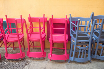 Colorful stacked traditional wooden chairs closeup