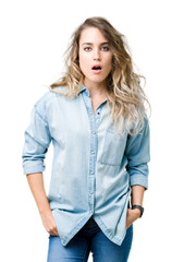 Obraz premium Beautiful young blonde woman over isolated background afraid and shocked with surprise expression, fear and excited face.