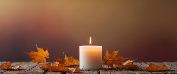 Autumn background with burning candle and leaves