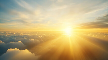 Beautiful sunset with sunbeams shining through clouds viewed from airplane window, providing tranquil and inspirational atmosphere