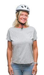 Middle age caucasian cyclist woman wearing safety helmet over isolated background looking away to side with smile on face, natural expression. Laughing confident.