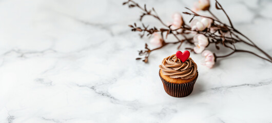 Vanilla cupcake muffin with a red heart on whipped mocha mousse on kitchen background. banner template for love, sweets, poster, and cards for party, birthday and Valentine's day with place for text.
