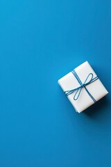 Photo of a white present box on a blue background, top view.