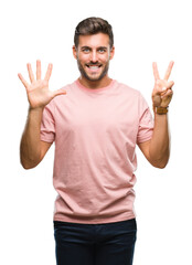 Naklejka premium Young handsome man over isolated background showing and pointing up with fingers number seven while smiling confident and happy.
