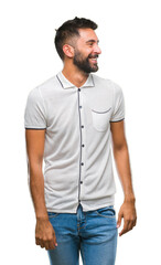 Fototapeta premium Adult hispanic man over isolated background looking away to side with smile on face, natural expression. Laughing confident.