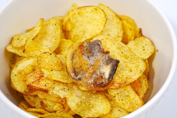 rotten potato chips. potato chips with spices in a bowl. 