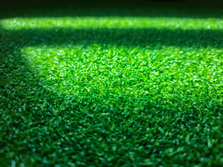 Naklejka premium Top view of artificial green grass texture background. Flat green grass texture background.