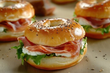 Tasty breakfast burger featuring prosciutto cream cheese and lettuce along with a ham bagel in close up view