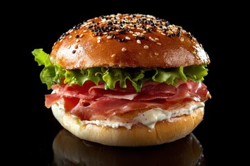 Tasty breakfast sandwich featuring prosciutto cream cheese and lettuce on a bagel with ham zoomed in