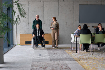 A diverse team of business colleagues, including a director in a wheelchair, engages in a...