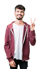 Fototapeta premium Young handsome man over isolated background smiling with happy face winking at the camera doing victory sign. Number two.