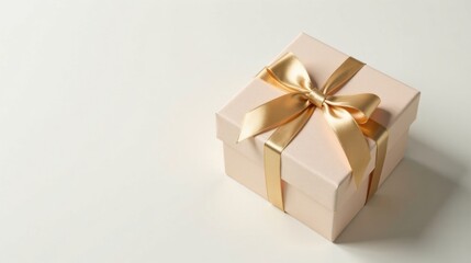 Obraz premium Elegant blush pink gift box with a gold ribbon bow