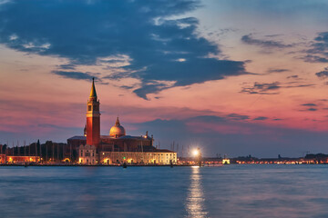 Obraz premium Scenic view of St George Church and Island in the Giudecca Canal, as seen at night from St Mark's district in Venice