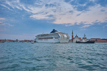Criuse ship with two tugboats at the Punta della Dogana at night, Venice