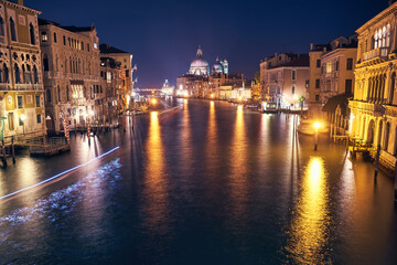Cityscape image of Grand Canal in Venice, with Santa Maria della Salute Basilica in the background.