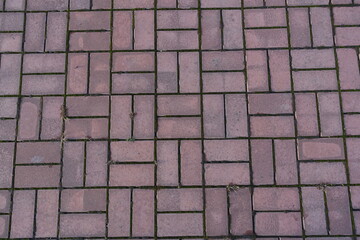 Obraz premium Surface of pink concrete pavement with double basketweave layout