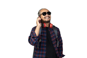Indonesian curly haired male backpacker is on voice call while traveling, travel concept, isolated...