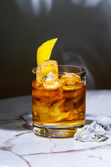 Spiced tequila old fashioned, alcoholic cocktail drink with tequila, soda, ice and lemon peel....