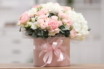 Beautiful bouquet in box on table at home