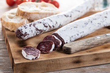 Fuet.Dry cured fuet sausage on wooden table