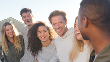Group Of Young Friends Outdoors Talking And Laughing Together