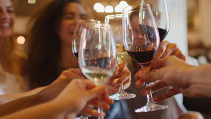 Close Up Of Group Of Friends Celebrating Doing Cheers With Glasses Of Red And White Wine Together