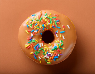 Glazed doughnut against mocha mousse background