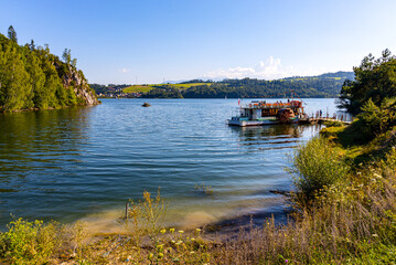 Obraz premium Panoramic view of Jezioro Czorsztynskie lake and reservoir on Dunajec river with touristic pier and ferry boat in Lesser Poland