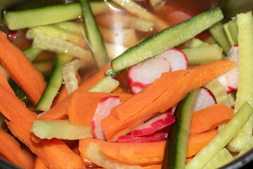 Close Up of Sliced Vegetables being Pickiled Carrot Radish and Cucumber