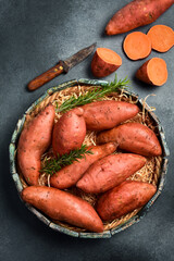 Basket of raw sweet potatoes. Organic sweet potatoes. Top view.