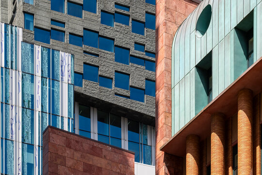 A diverse range of architectural facades stands together in this image, reflecting contemporary design and creating visual interest within an urban landscape  in Amsterdam