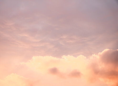 Serene Sunset Sky with Soft Pastel Clouds Illuminated by Warm Evening Light
