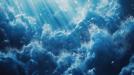 Blue ocean waves from underwater with bubbles. Light rays shining through. Great for backgrounds.