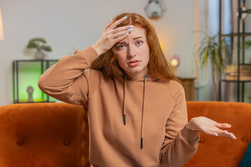 Face palm. Shame on you. Upset woman with red hair making disrespect gesture, feeling bored...