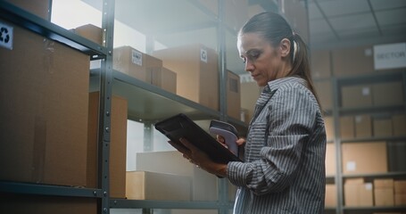Female Warehouse Associate Scans Cardboard Box with E-Commerce Orders Using Scanner, Checks...