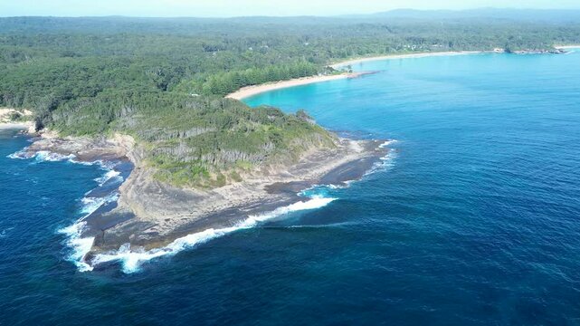 Drone aerial landscape of Mill Point and Wasp Island head ocean coastline with bushland forest and sandy beaches South Durras Australia suburbs town travel tourism bay