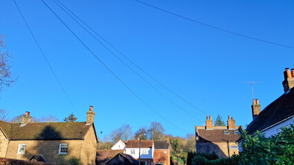 Fototapeta premium Aerial view of English countryside village with charming tiled rooftops.