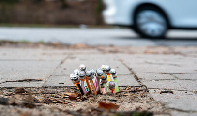 Fiber-optic cables coming out of the ground on a sidewalk.  Picture taken during the process of...