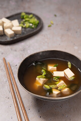 Traditional Japanese Miso soup with Wakame seaweed and tofu cheese with chopsticks for single serving. Vegetarian, vegan and healthy concept. Asian food.