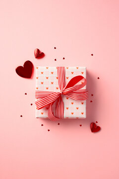Valentine's Day gift box with hearts on pastel pink background. Shopping, sale, promotion concept.