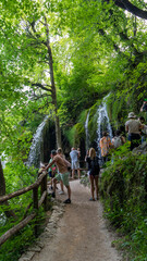 Plitvice Lakes Croatia June 30, 2024 People in the Plitvice Lakes National Park. Transparent Turquoise Colored Waters of the Lake Are Having Ripples. Many Small Waterfalls Flowing Into the Lake.