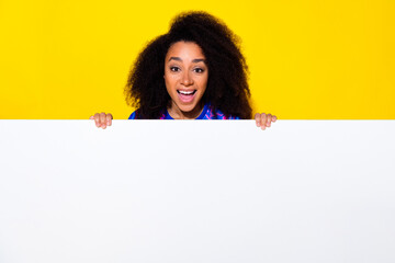 Photo of attractive young woman hide behind empty white space dressed stylish colorful blue clothes...