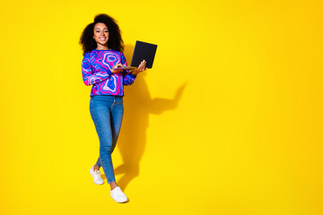 Full size photo of pretty young girl walking hold netbook wear trendy colorful blue outfit isolated...