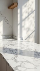 Interior with marble countertop, with a wooden shelf and shadows from a window creating light patterns.