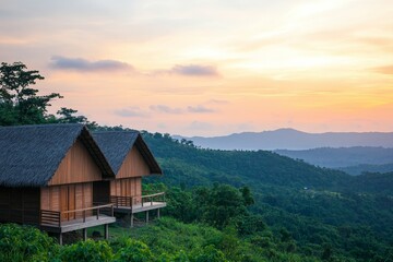 Fototapeta premium Sustainable living tips concept. Scenic wooden cabins nestled in lush green hills at sunset.