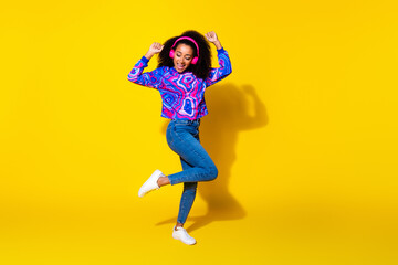 Full length photo of lovely young lady dancing earphones dressed stylish colorful blue garment isolated on yellow color background