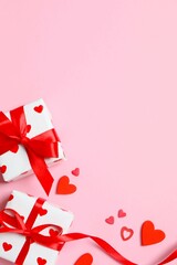Beautiful gift boxes with red hearts on color background