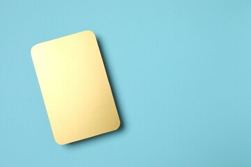 Golden paper card on color background